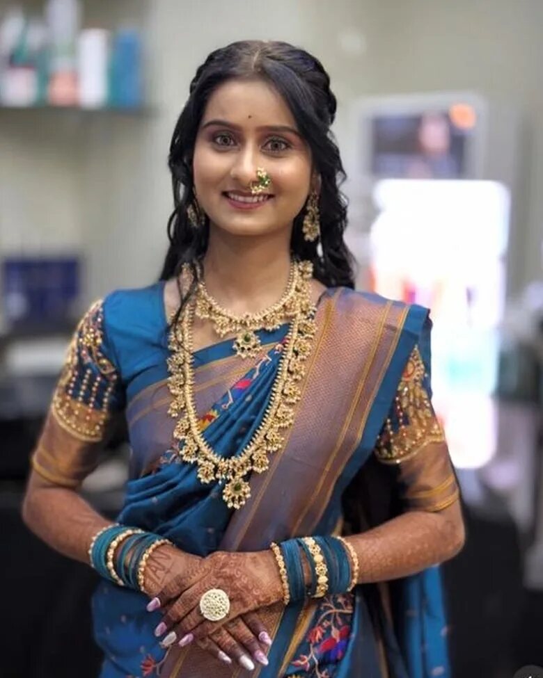 Maharashtrian nauvari bridal makeup and hairstyling at The Sarita's Lounge, Wagholi